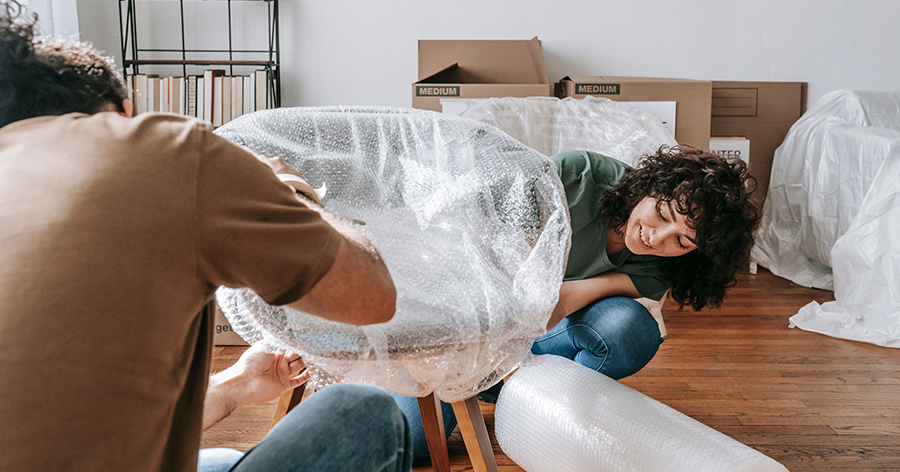 a man and woman wrapping their chair for storage