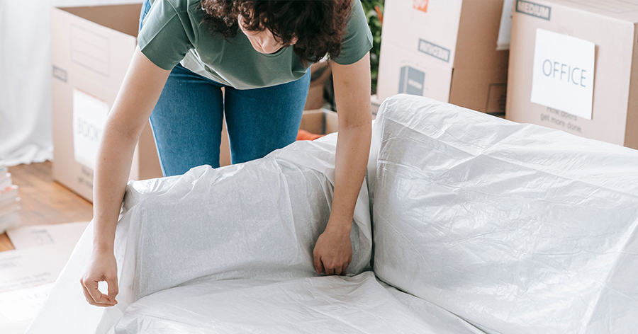 a woman wrapping her couch