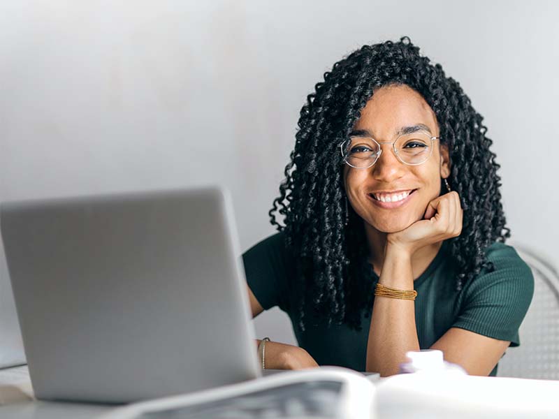 Woman smiling at laptop