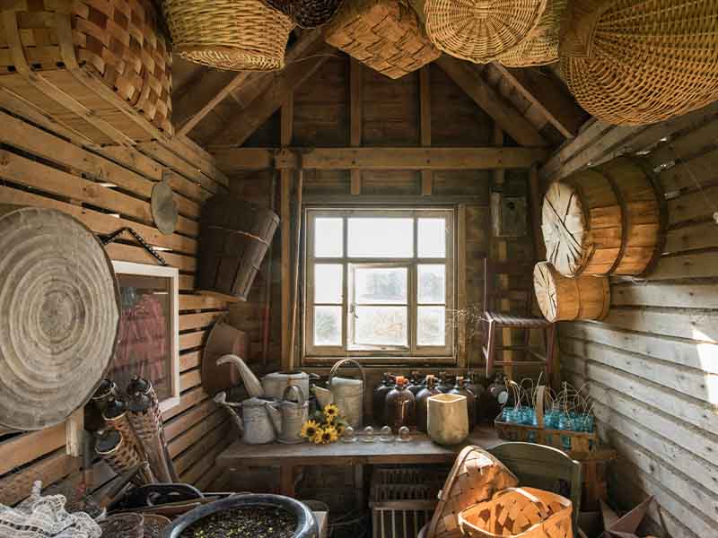 Brown wicker baskets hanging in shed.