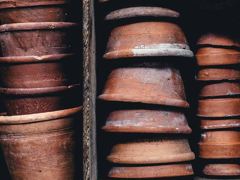 Clay pots stacked on wooden shelves