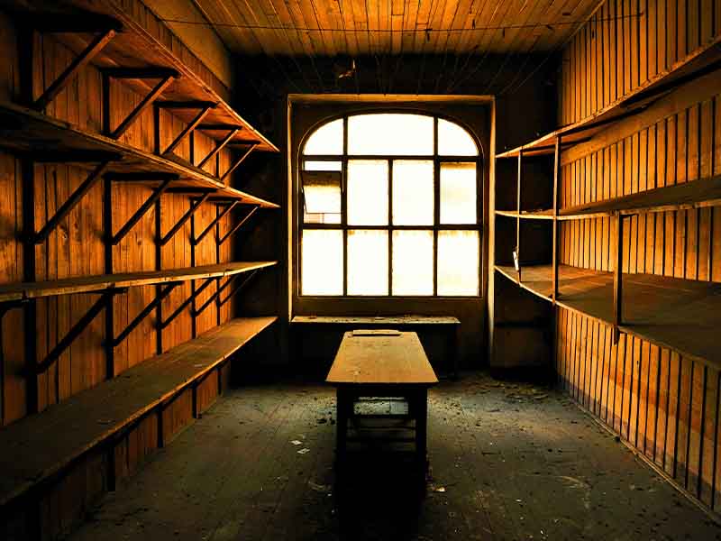 Empty wooden attic with shelves on walls