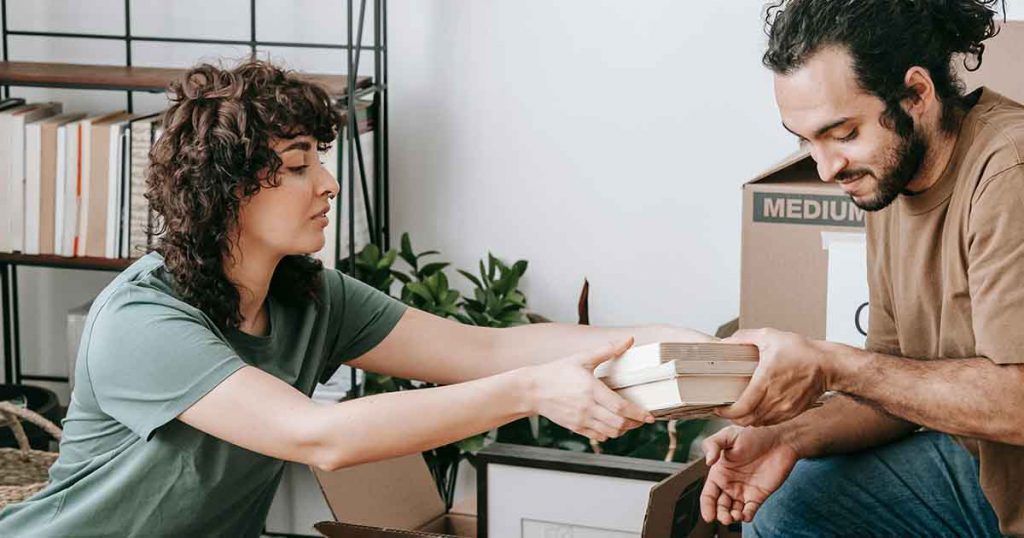 Couple packing moving boxes