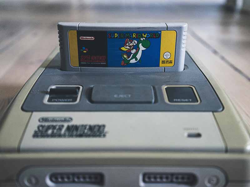 Vintage Gaming Console with Mario game cartridge
