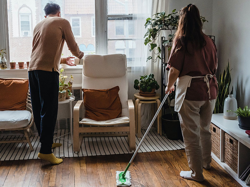 Couple cleaning their apartment