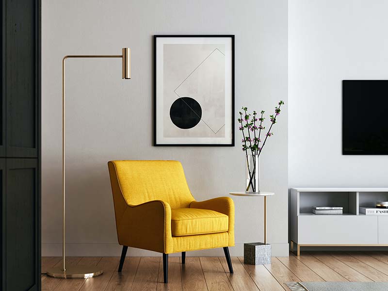 Designed space with yellow chair and black and white wall art