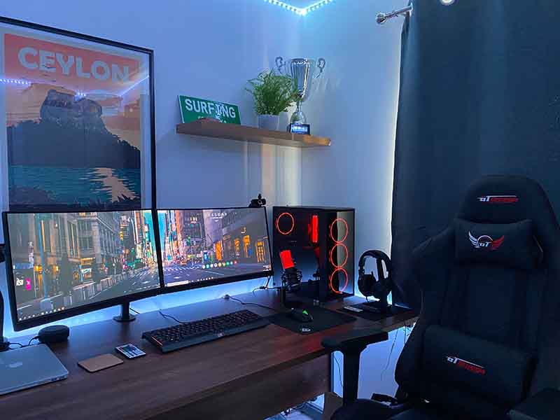 Gaming room with posters, monitors, and gaming chair