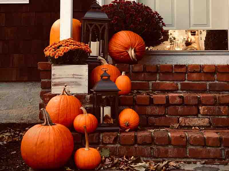 Pumpkins and candles on fall steps