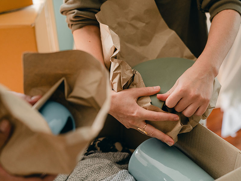 People packing ceramic bowls