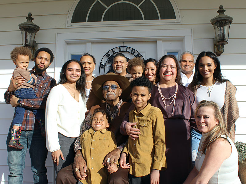 Family standing in front of the home