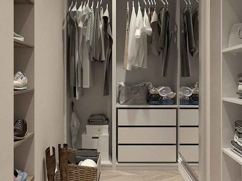Closet with tall shelves and clothing
