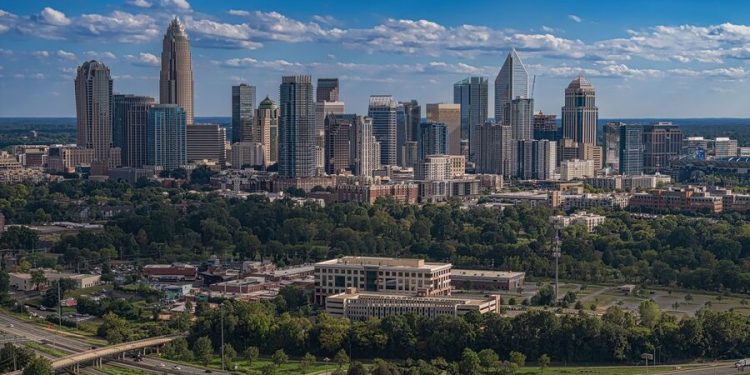 Aerial view of the Charlotte city skyline with Uptown skyscrapers surrounded by some of the best neighborhoods in Charlotte.