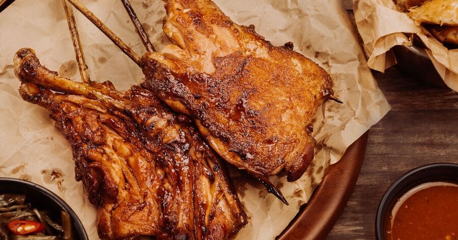 Barbecue-style smoked chicken served with classic Southern sides and a dipping sauce.