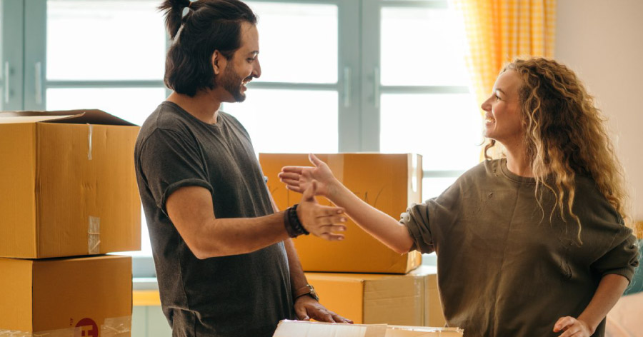 A couple is high-fiving after packing things up to be put in storage during home renovations.